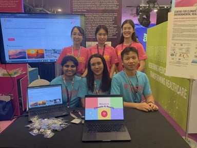 CCEH team at the booth displays research on climate change and human health, with laptops, posters, and an interactive screen showcasing the Centre’s initiatives