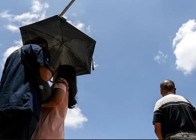 Intense heat and people with umbrella