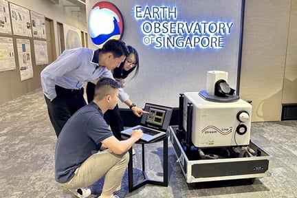 NTU's Associate Professor Steve Yim (centre), Dr Huang Tao (front) and Dr Fang Tingting looking at data collected by the upcoming light detection and ranging station.