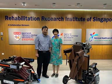 Assoc Prof Ang Wei Tech and Adjunct Assoc Prof Karen Chua with the social assistive robot