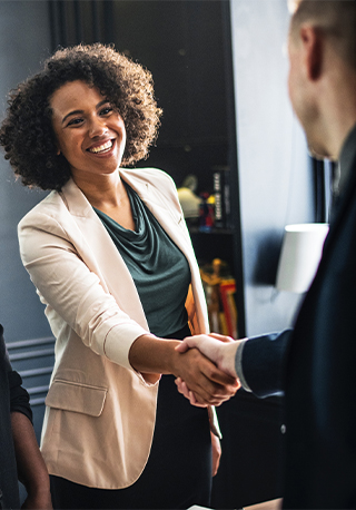 Two young business executives shaking hands