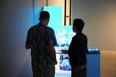 Visitor (left) and artist Sarah Choo (right) looking at the latter's work A Walk in the Park