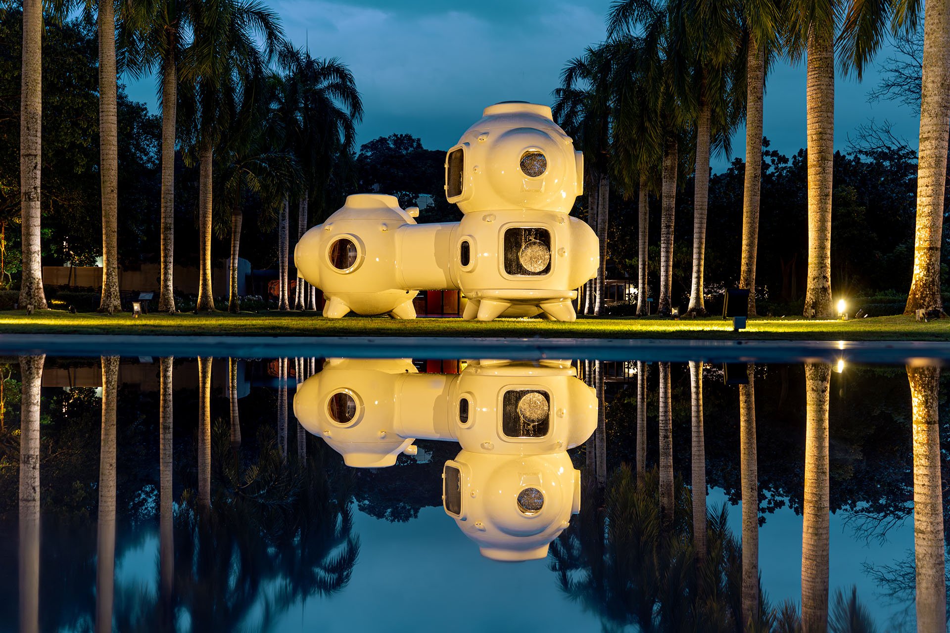 Installation view of Cosmos of Nostalgia by Torlarp Larpjaroensook, night shot with water reflection