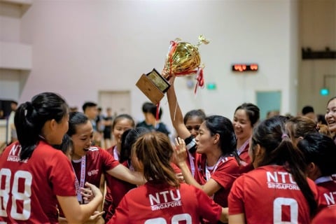 NTU Floorball Women's team celebrating their victory at the Institute-Varsity-Polytechnic Championships 2019/20 with their championship trophy