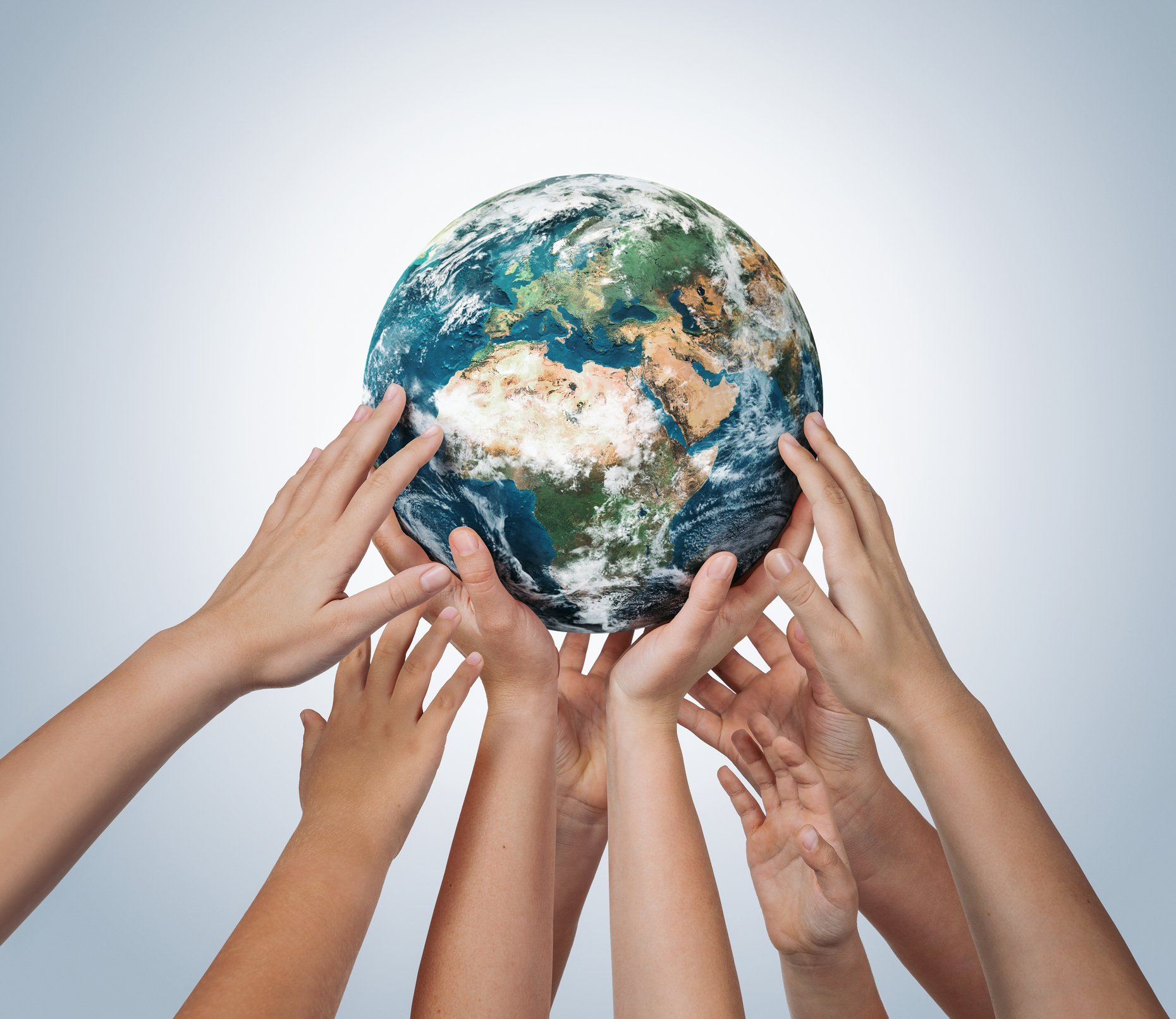 Many children hands holding planet earth