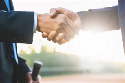 Men shaking hands during a meeting in outdoors background