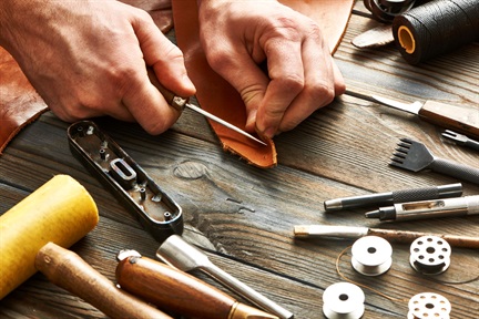 Man working with leather using crafting tools