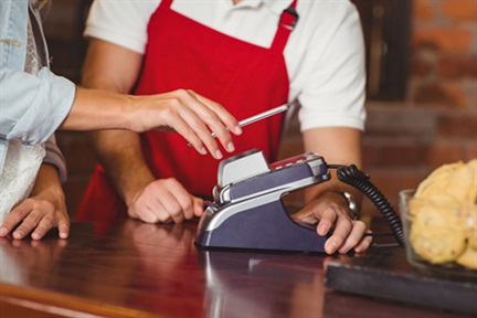 Close up customer hands making a mobile payment at the coffee shop