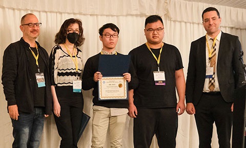 Photo of a distinguished paper award announcement ta ASE 2022