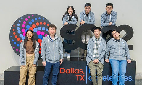 Thumbnail group photo of 6 University students and a lecture standing beside the SC22 award prop.