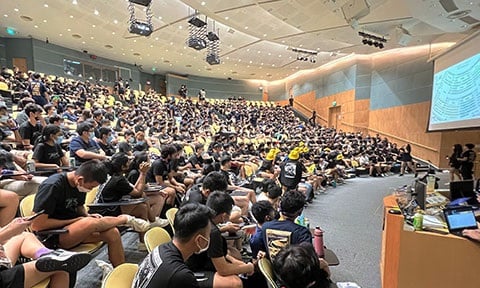 Group photo of the university students in a Lecture Theatre.