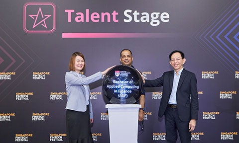 Thumbnail photo of two Profs launching new UG programme on stage with an officer standing in-between them.