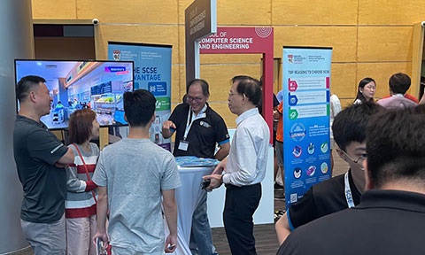 Photo of faculty interacting with visitors during NTU Open House 2023.