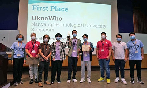 Thumbnail photo of university students winning an award on stage.