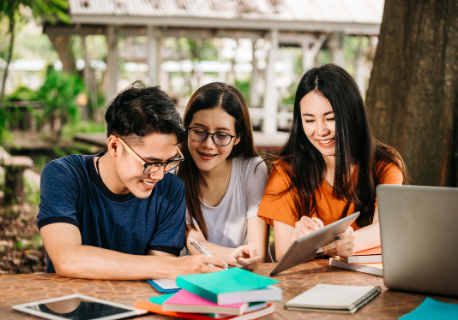 Three students are happily studying