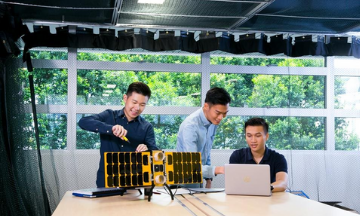 Three EEE students working on satellite project