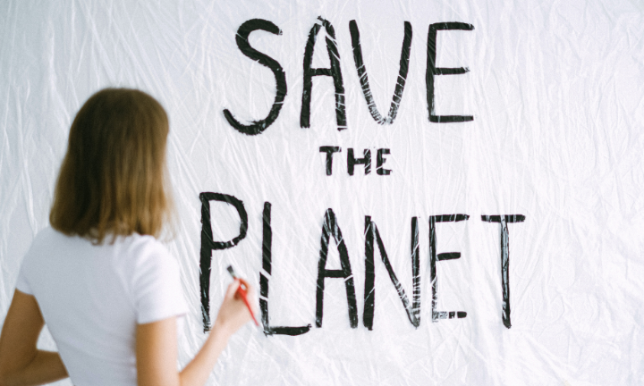 Girl painting save the planet text