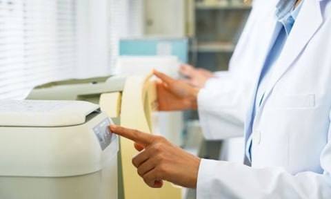 Group of researchers using scientific equipment