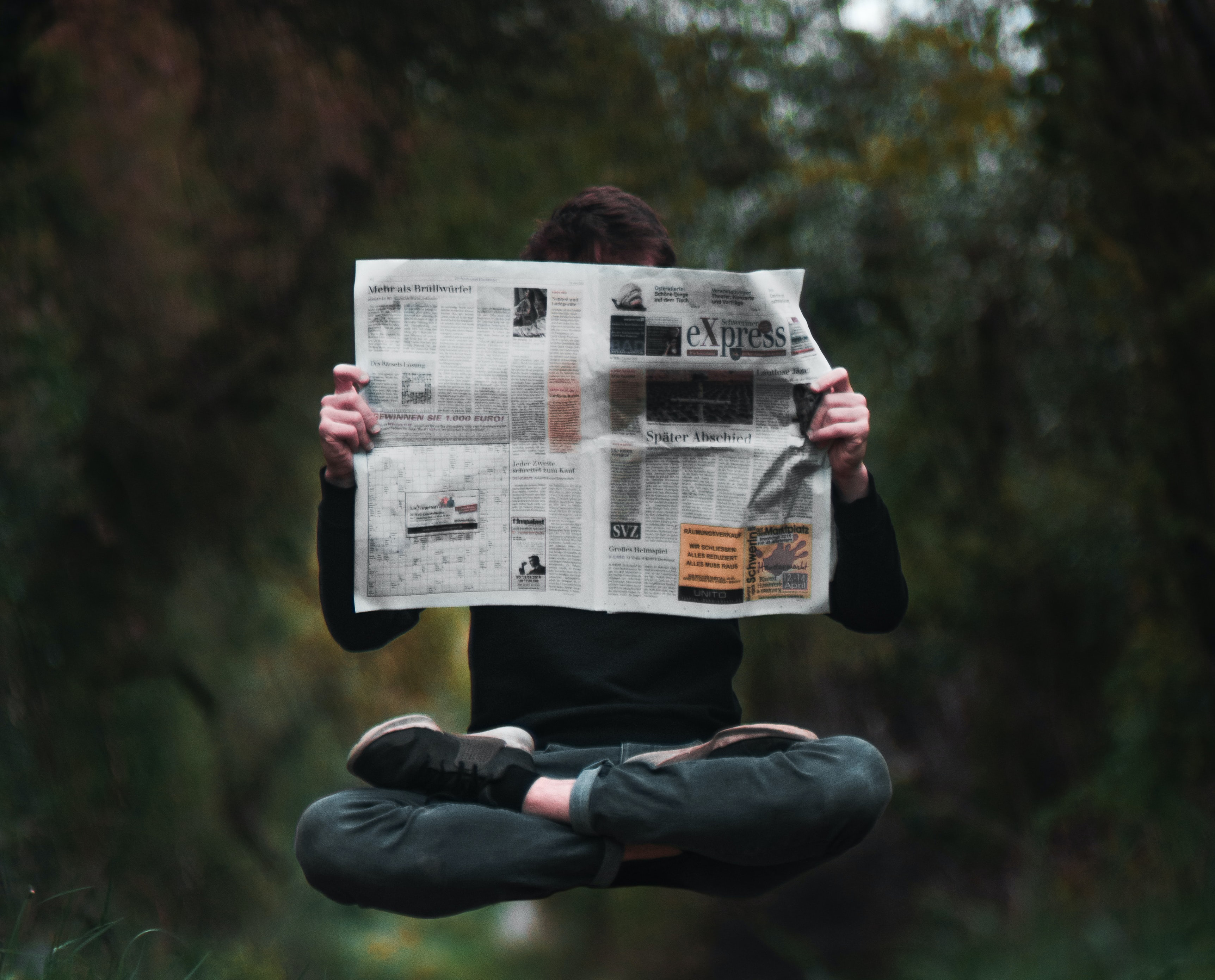 Person reading a newspaper 2