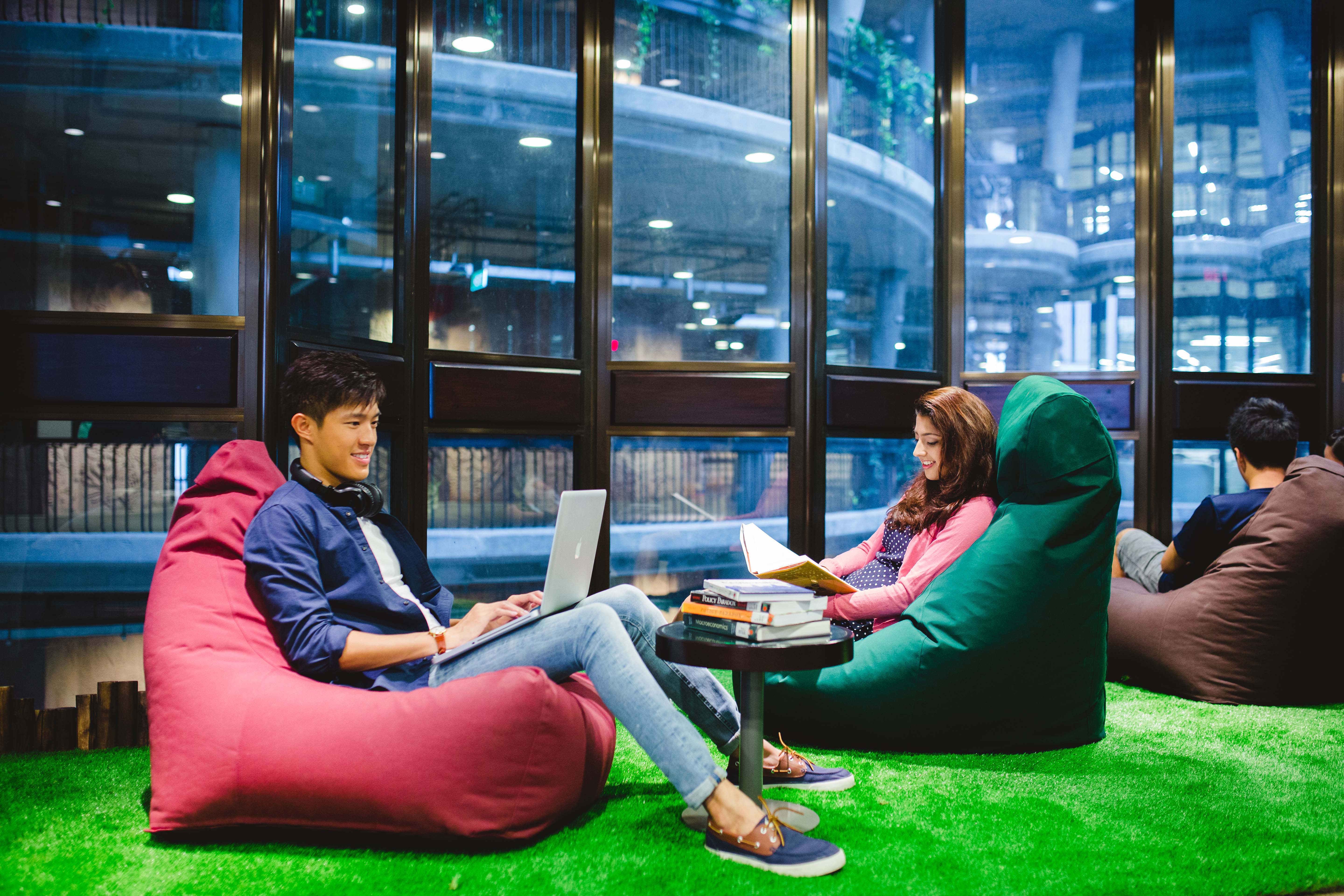 Students reading and studying on beanbag chairs