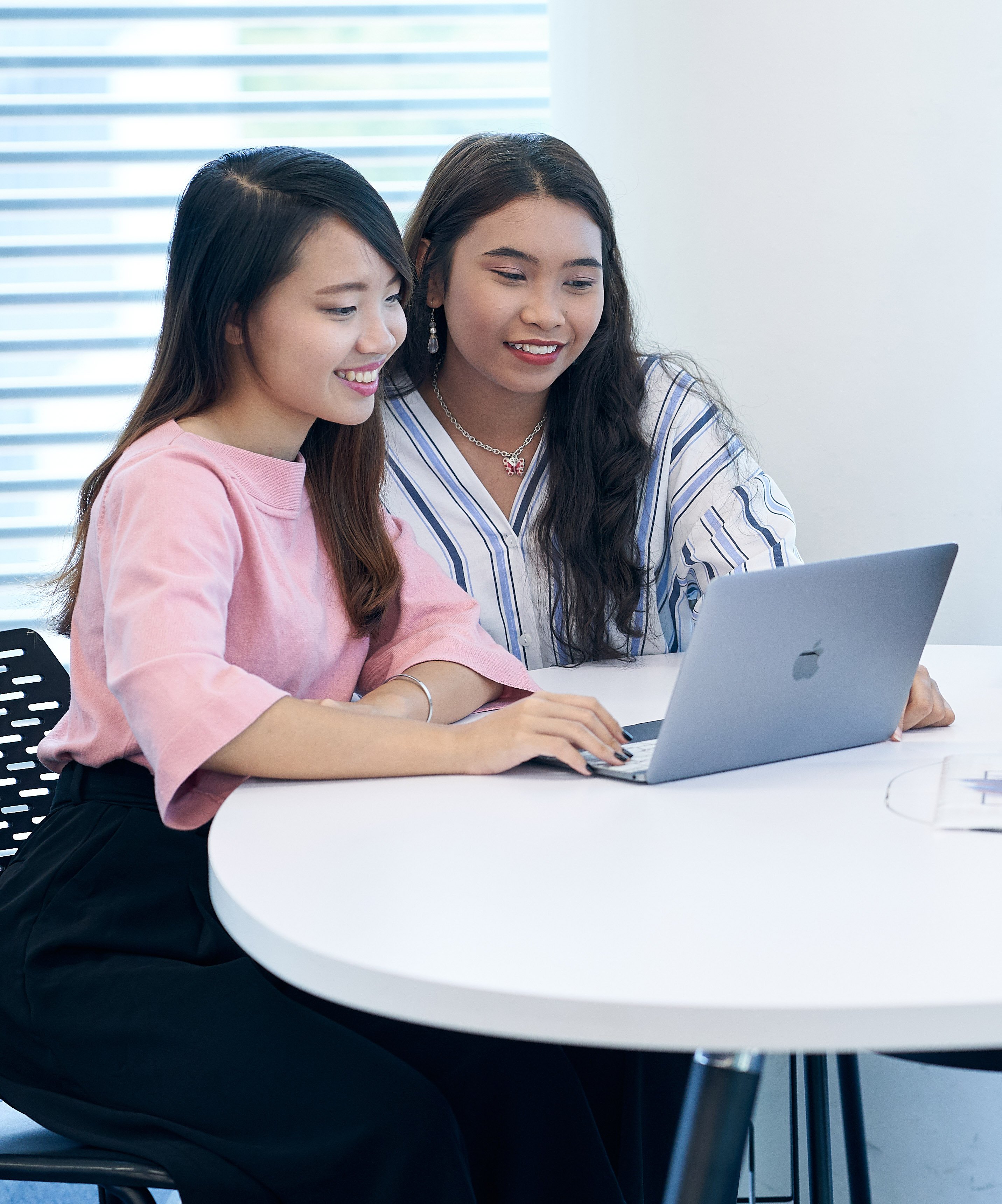 two students sharing a laptop 