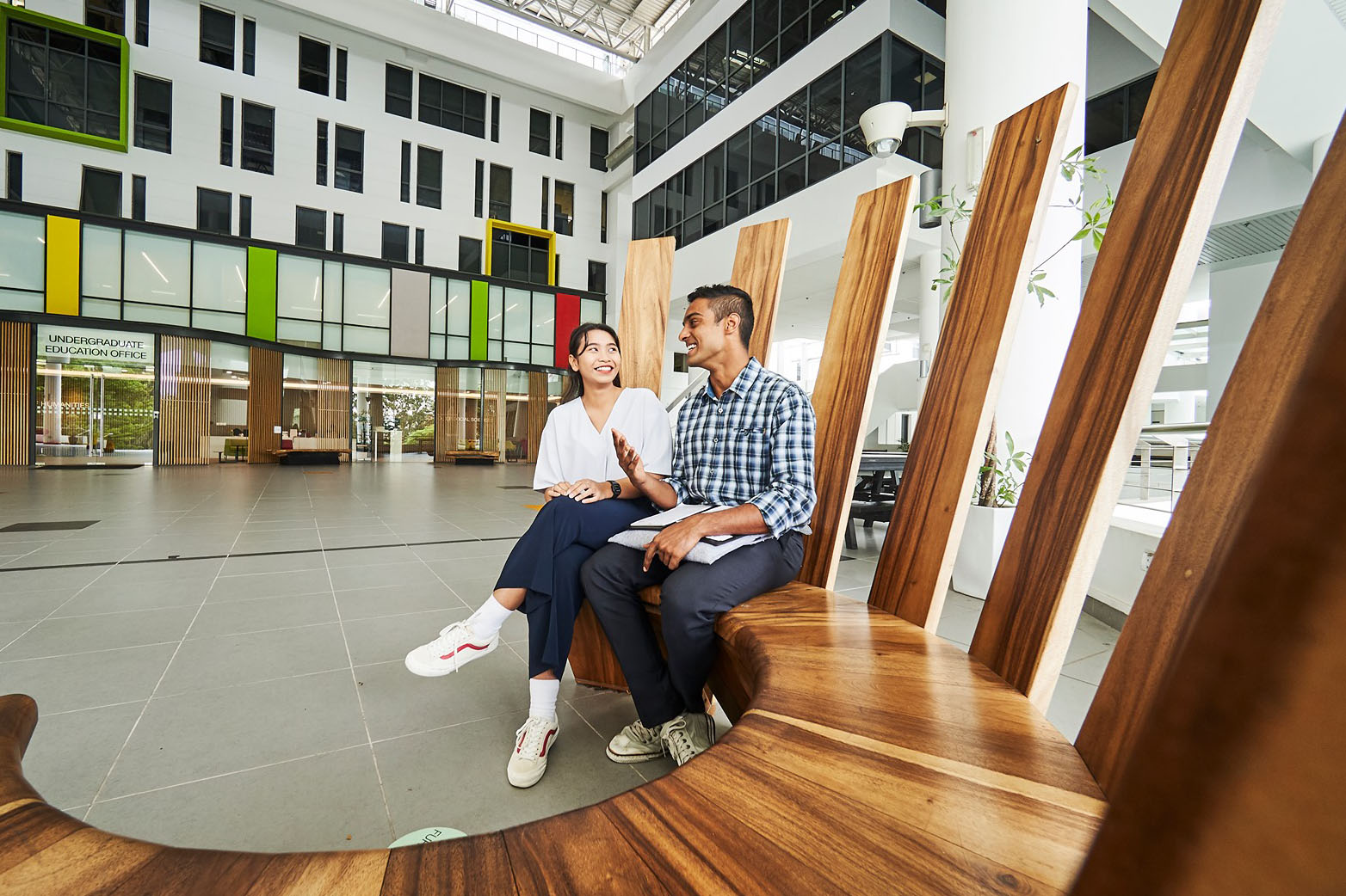 two students talking on a bench