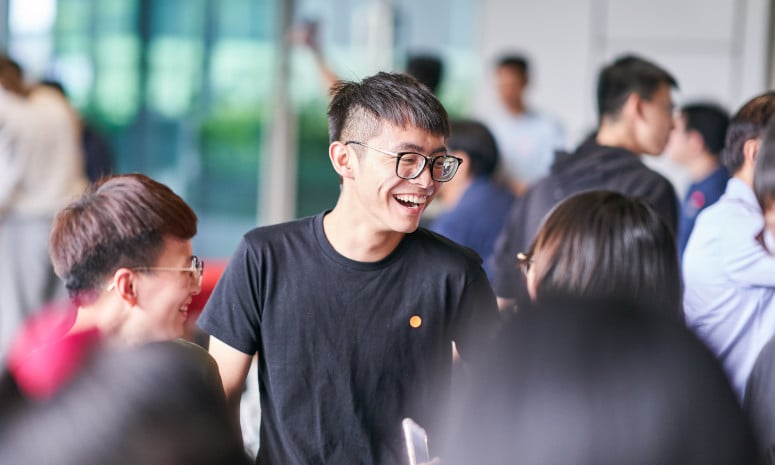 Student laughing in crowd