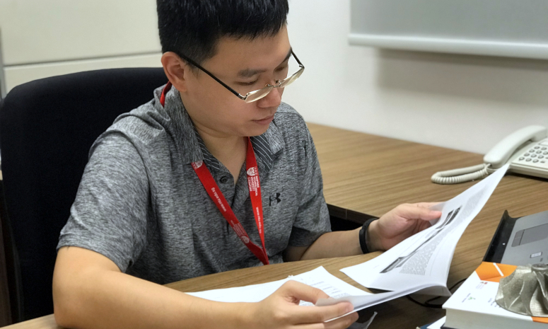 Researcher reading journal paper