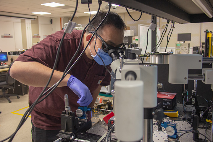 Researcher adjusting sample