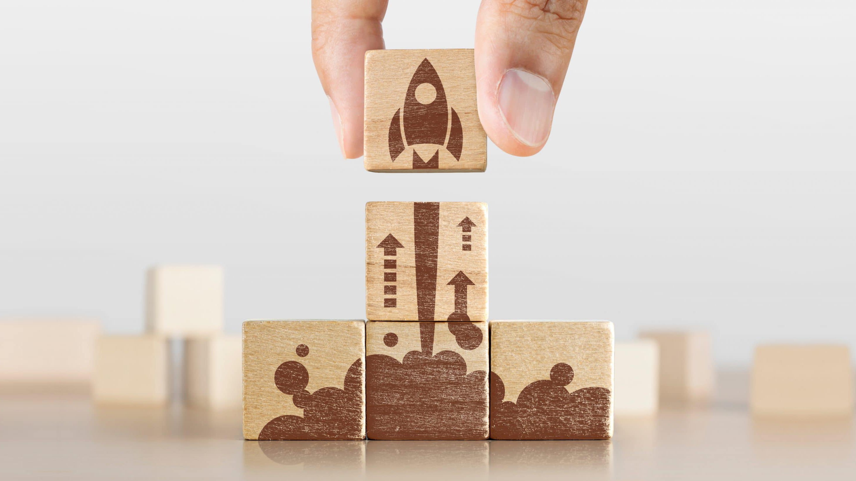 Wooden building blocks of a rocket blasting off into space