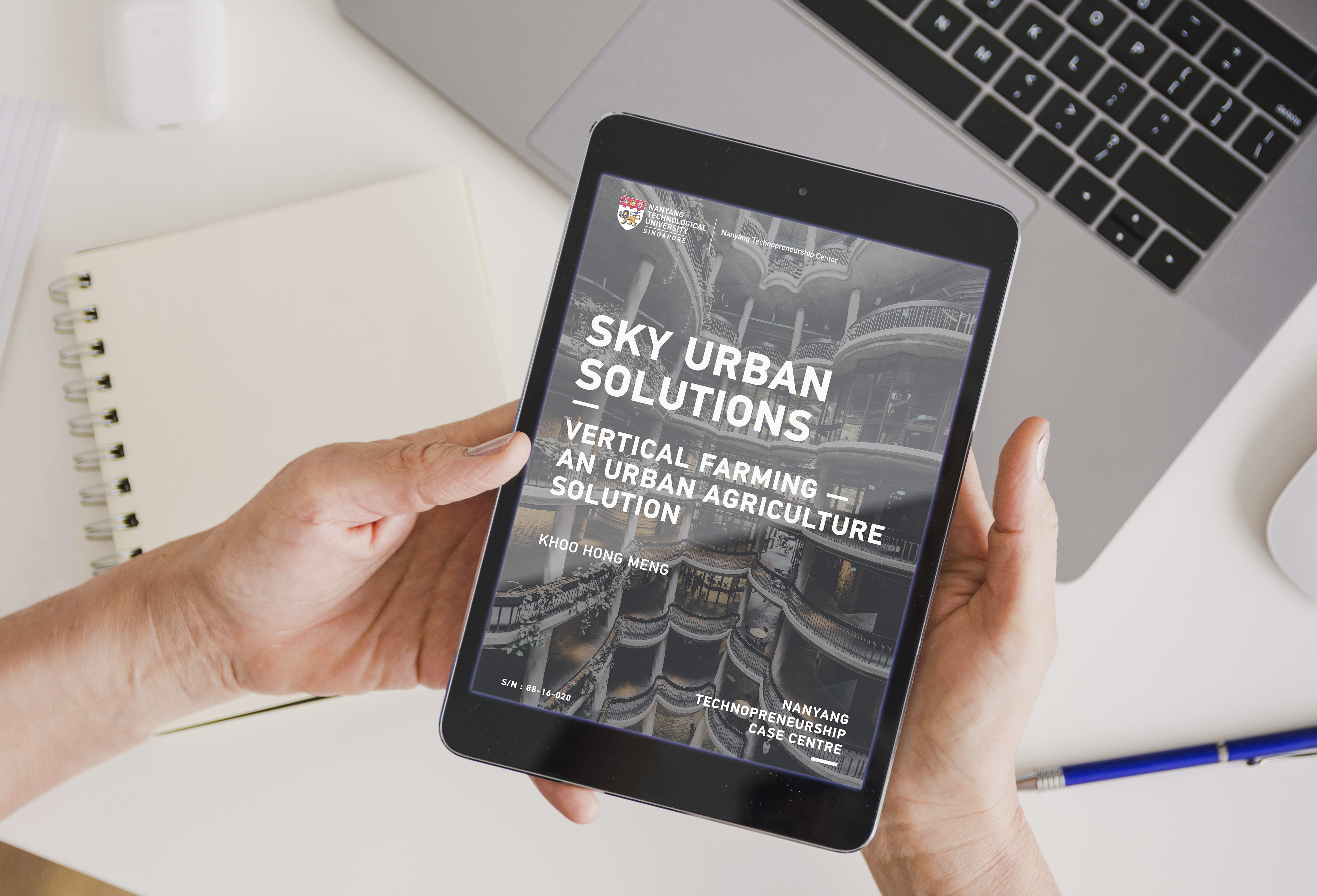 Reading a technopreneurship case study on an iPad.