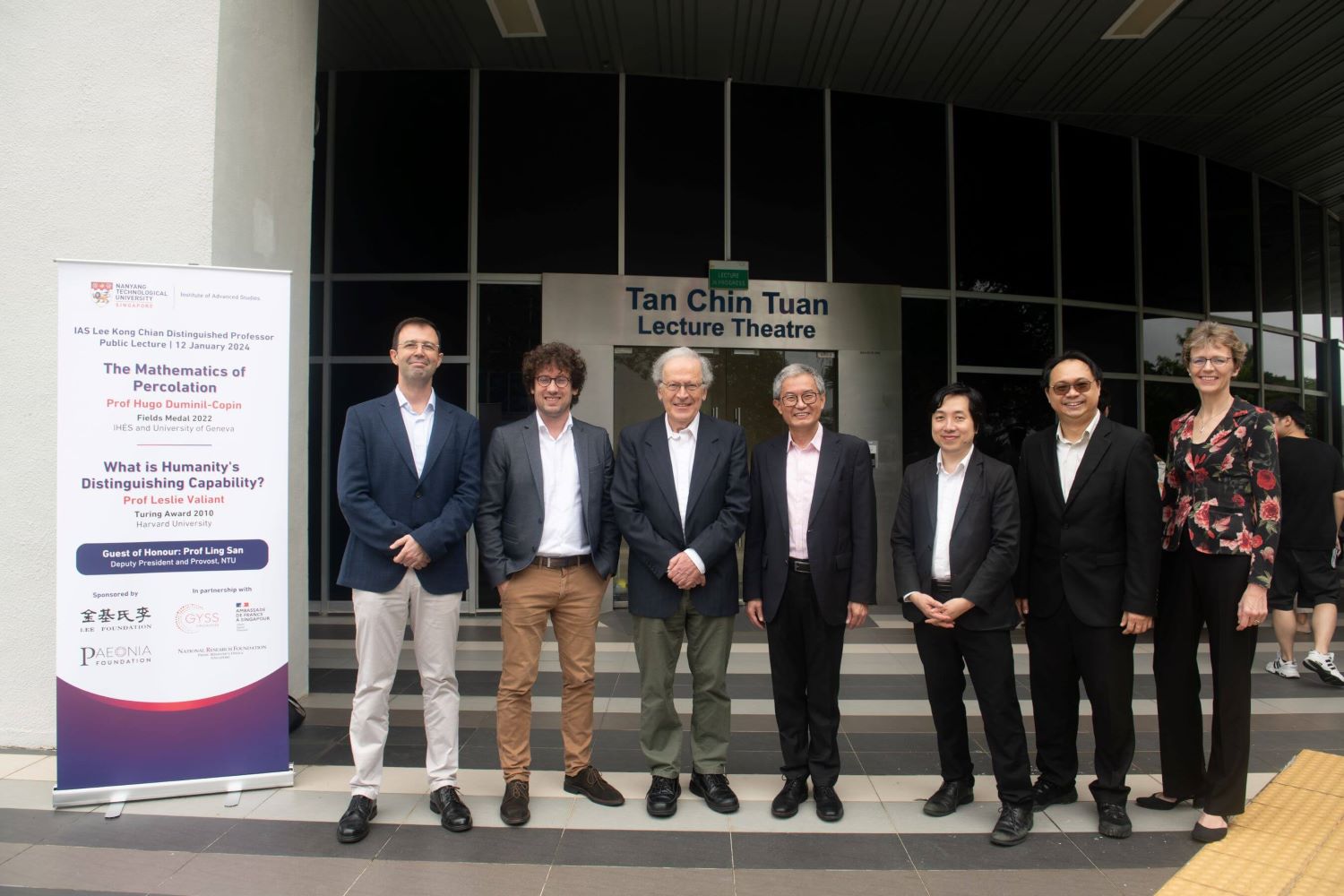 Prof Hugo Duminil-Copin and Prof Leslie Valiant alongside Prof Ling San, accompanied by NTU members