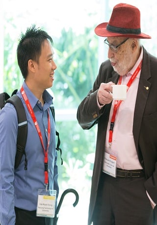 Student discussing with Nobel Laureate