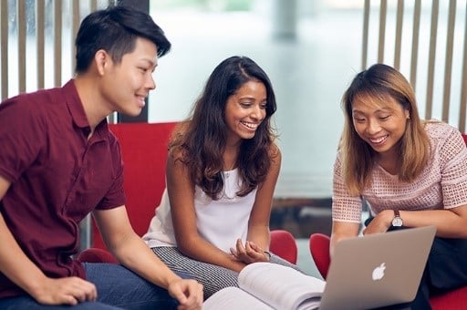 Group of International Trading Programmes students working together on a laptop