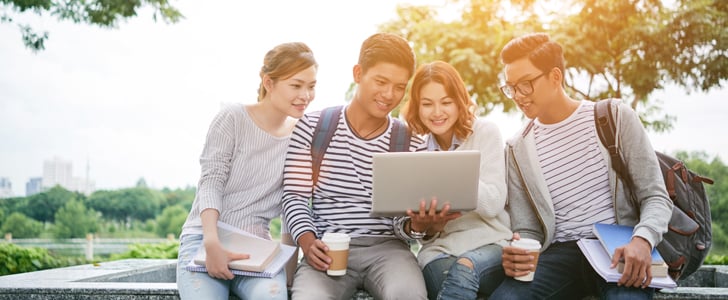 Centre of Excellence International Trading students working together over a coffee