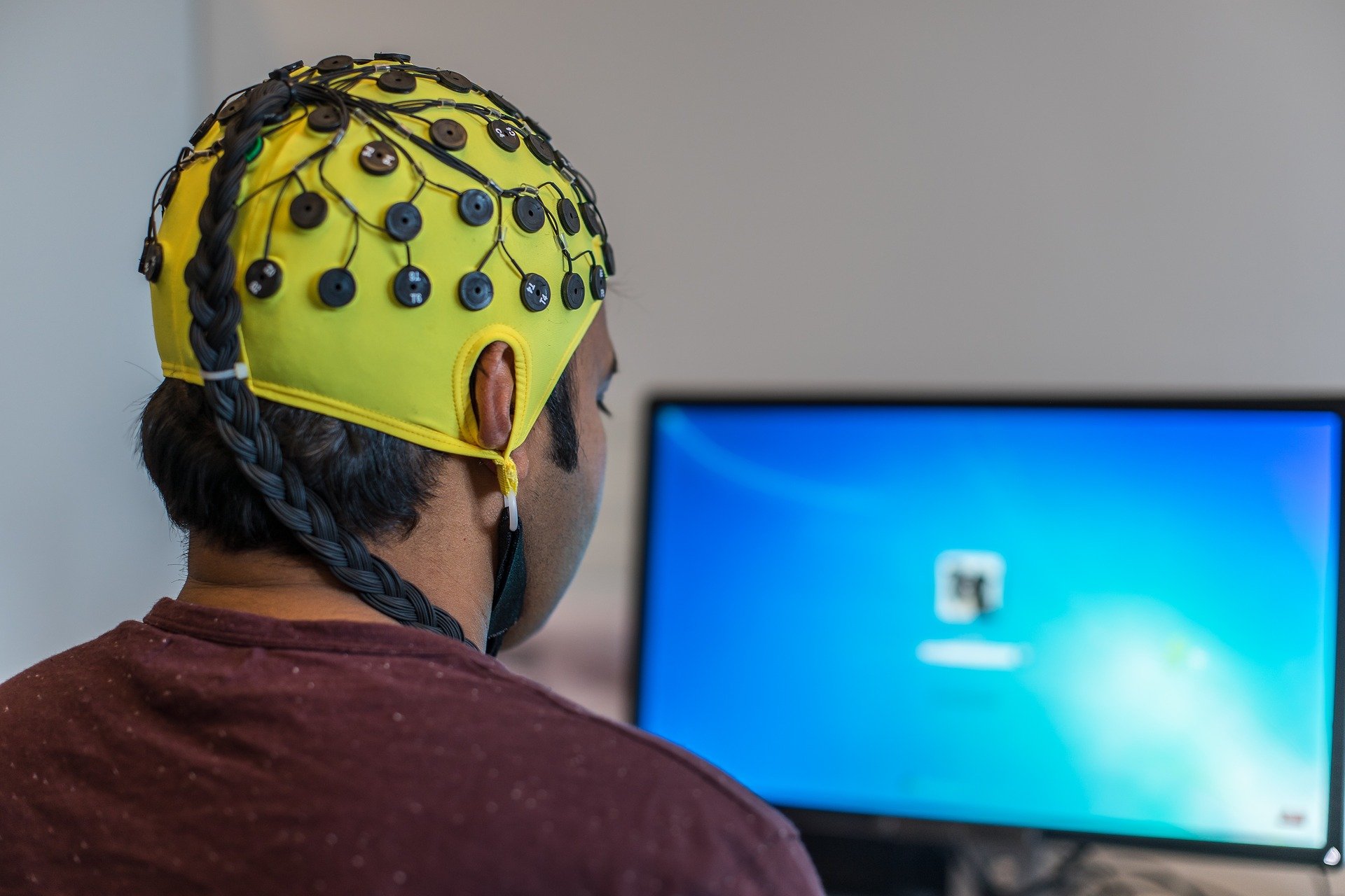 A man wearing an EEG hat