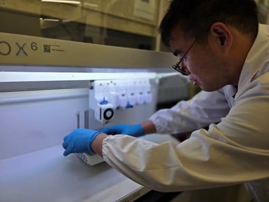 Researcher Boyang Huang loads the BIO X6 extrusion-based 3D bioprinting device