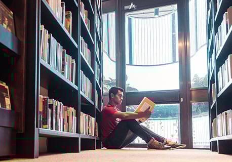 Nanyang Business School student reading in library at Nanyang Technological University, Singapore