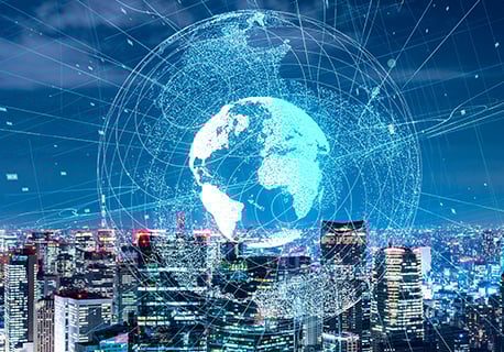 A globe graphic icon against a range of city skyscrapers at night