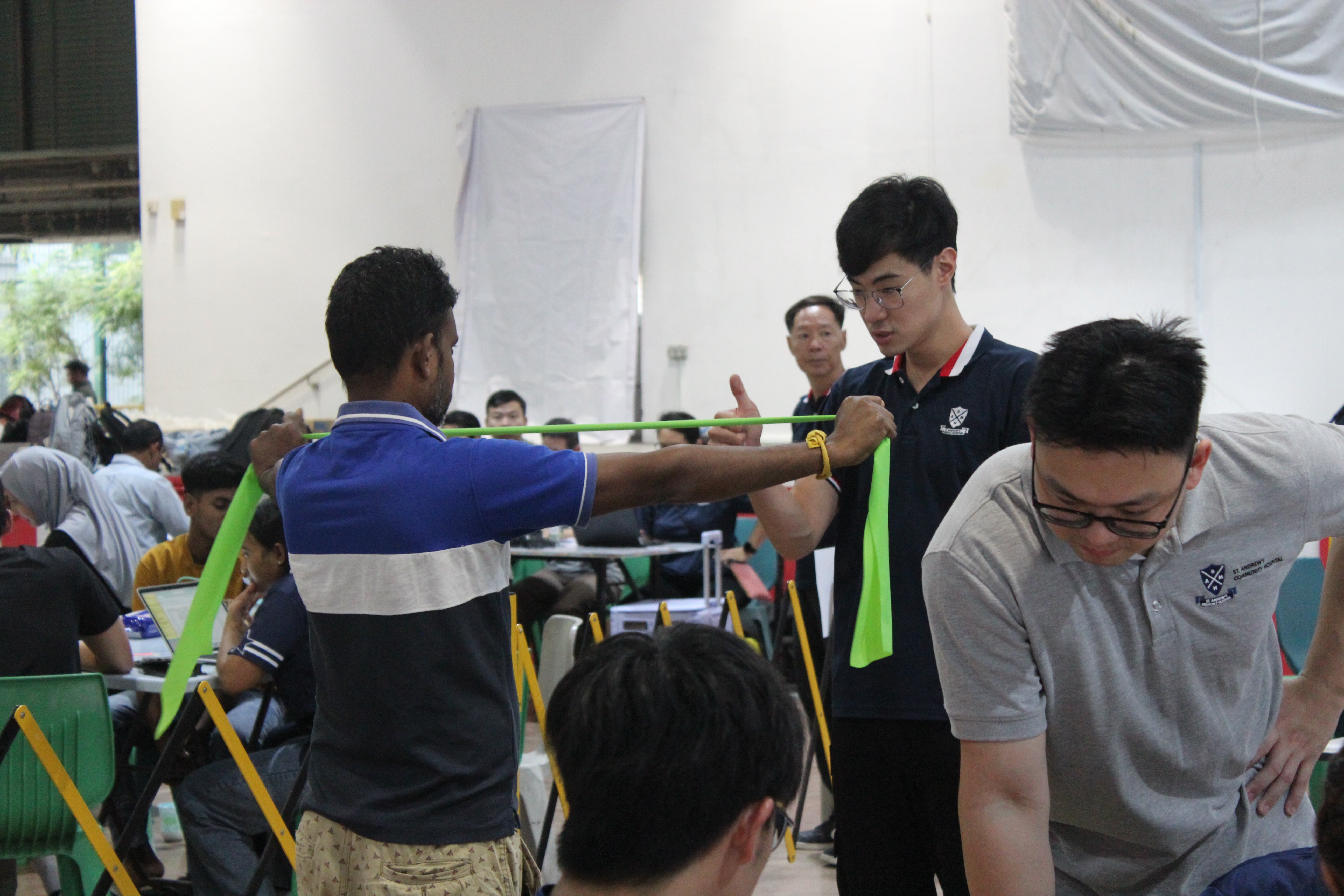 Educating our Migrant Brothers on resistance band exercises!