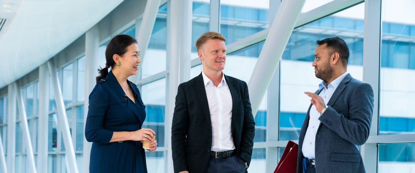 Three Nanyang Executive MBA faculty members having a discussion