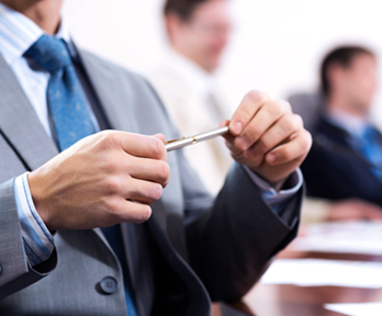 Business professional on a management training course, holding a pen
