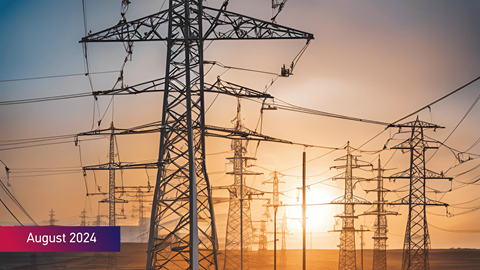 Electric utility poles in a field during sunset with August 2024 text on bottom left