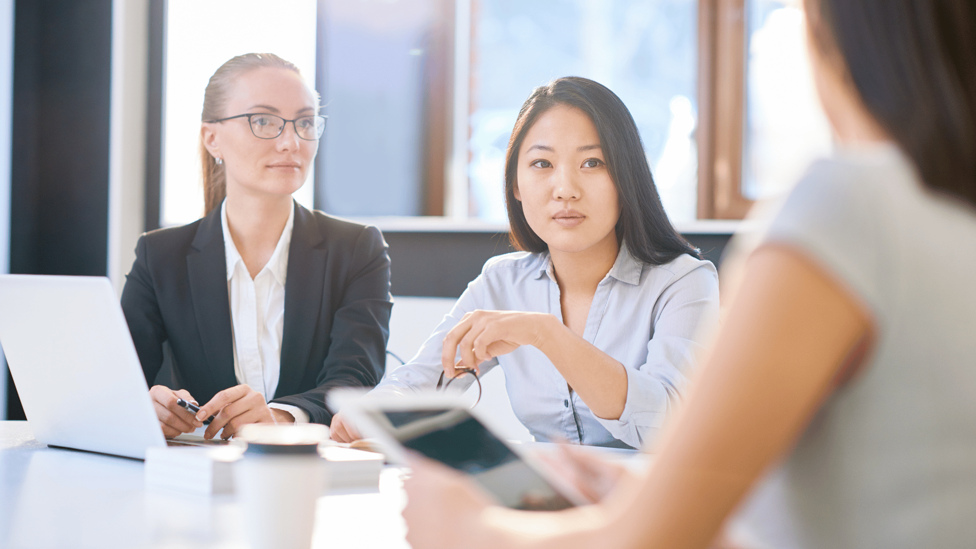 Attentive multiethnic businesswomen listening to boss while working on a project together