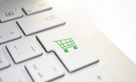 Stock image of a shopping cart icon on a computer keyboard