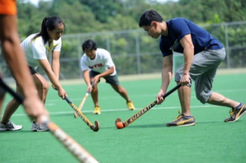 Cheryl Tay, Victoria and Alex Mok playing Hockey at NIE Pitch