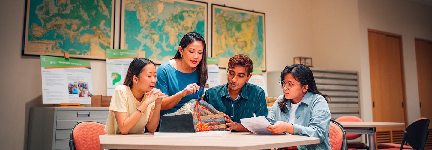 A Volcano Model Discussed by Science Teacher and Group of 4 Young Adult Students