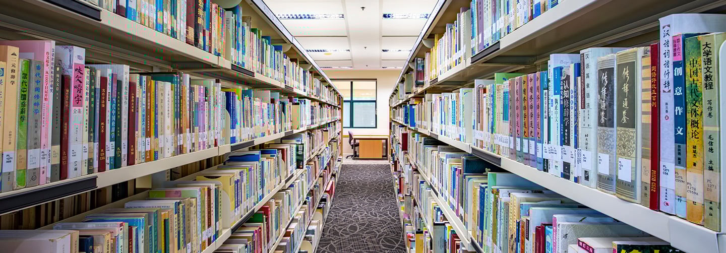 In Between Shot of Shelves of Books in a Library