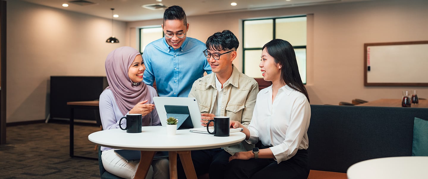 iPad Young Malay Male in Cream Outerwear Jacket in Group of 4 in Business Lounge