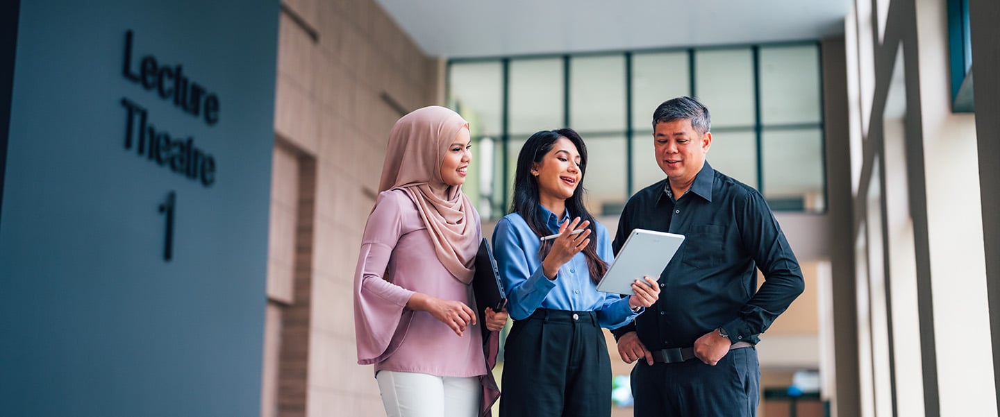 Lecture Theatre 1 Lady in Blue Top and Malay Girl Wearing Pink Tudung with Senior Male Teacher